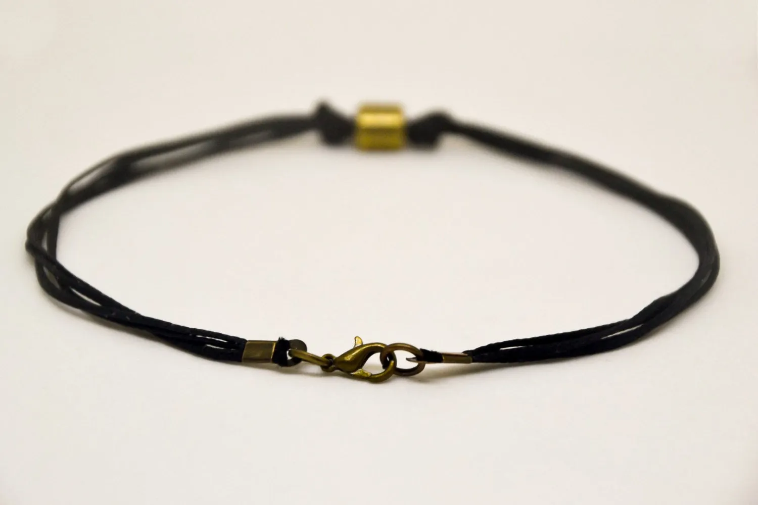 Men's anklet with a bronze tube charm and a black cord, gift for him