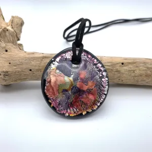 Necklace with shades of pink, purple, silver on black Murano glass circular flat pendant